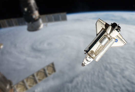 Space Shuttle orbiting the earth. Elements of this image furnish