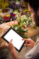 Male florist using digital tablet