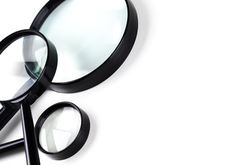 Three magnifiers over white
