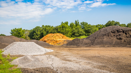 Asphalt Material Pit
Assorted mounds of dirt and gravel used to make asphalt for road pavement.