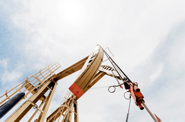 Oil pump. Oil industry equipment with blue sky