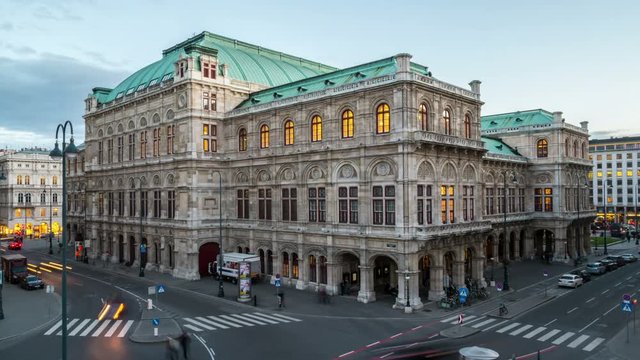 View of State Opera in Vienna, Austria during the night. Cloudy sunset sky, car traffic. Evening to night time-lapse