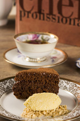A slice of rich chocolate cake with ice cream and coffee
