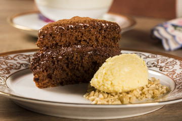 A slice of rich chocolate cake with ice cream and coffee