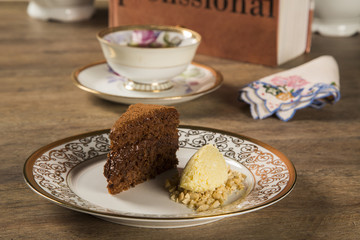 A slice of rich chocolate cake with ice cream and coffee