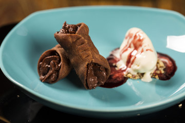 Cannoli with ice cream, chocolate and almonds