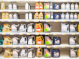 Blurred motor oil on shelves in supermarket