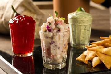 A delicious cup of Guacamole, hot pepper jelly, next to fresh in