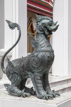 metal security dog in buddhistic temple of Thailand, Bangkok.