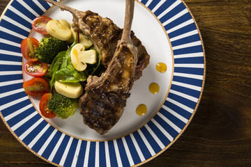 Rare fried rack of lamb with vegetables.