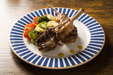 Rare fried rack of lamb with vegetables.