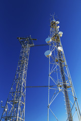 Fototapeta na wymiar Communication antenna towers on blue sky
