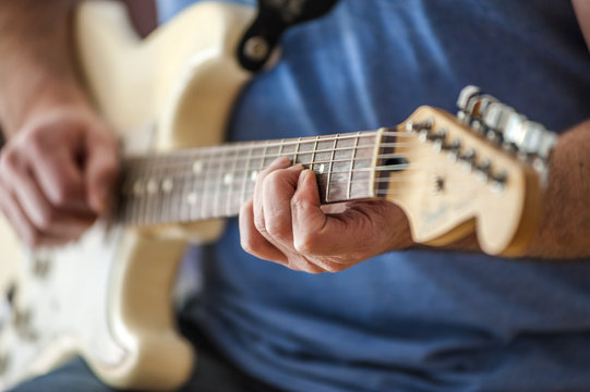 Close-up of man playing guitar