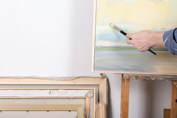 An artist painting in studio. Selective focus