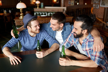 happy male friends drinking beer at bar or pub