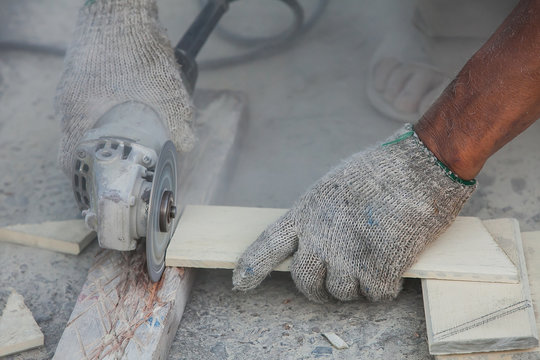 Senior Male Carpenter Using Table Saw For Cutting Wood At Worksh