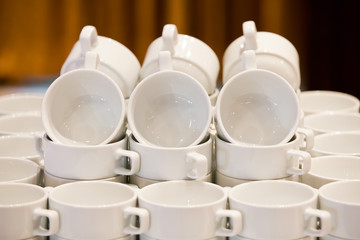 White cups for tea piled on table  for coffee-break