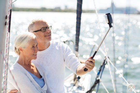 senior couple taking selfie on sail boat or yacht