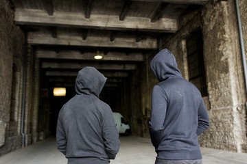 addict men or criminals in hoodies on street - obrazy, fototapety, plakaty
