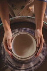 Close-up of female potter making pot
