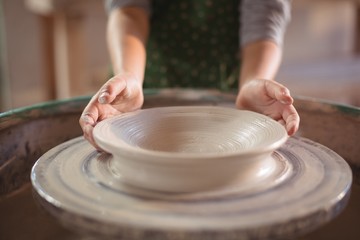 Mid section of girl making pot