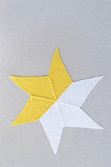 Hand-knitted star on concrete background.