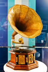 Vintage gramophone and platter on colorful background