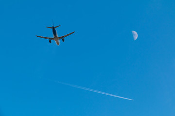 Plane taking off, plane high in the sky and moon.
