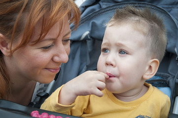 Young mother looking affectionately at her baby boy.