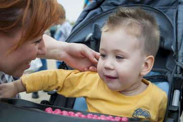 Young mother looking affectionately at her baby boy.