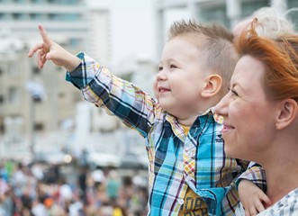 Impressed little boy pointing at something in the sky.