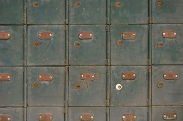 Fototapeta premium Wall of old green post office boxes in Sarawak, Malaysia
