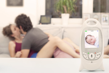 Couple enjoying free time while baby is peacefully sleeping on the monitor