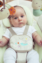 Close-up of baby in his swing