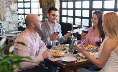 Adults having dinner in restaurant