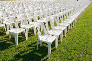 Fototapeta premium Rows of empty white chairs waiting for the audience