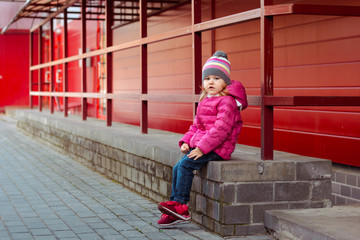 little fashionista, stylish girl on the streets. the child eats