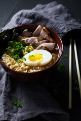 Asian noodles with pork, egg and greens