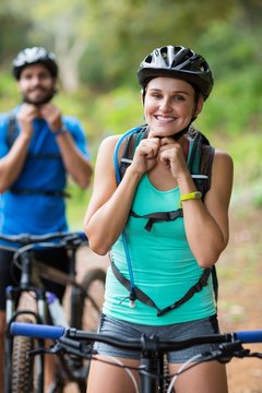 Athletic couple wearing bicycle helmet