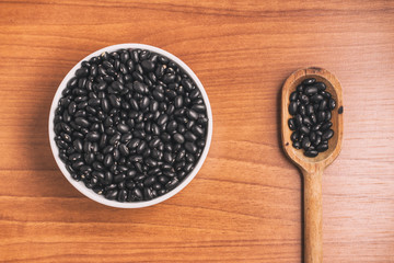 Black beans into a bowl and spoon. Phaseolus vulgaris 'Black tur