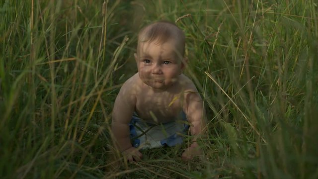 Happy baby in the summer on the nature