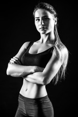 Fototapeta na wymiar attractive fitness woman, trained female body. Black and white photo.
