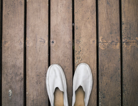 Dirty gray leather shoes on wooden floor ( Space and composition for text )