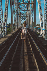 girl goes on railway bridge
