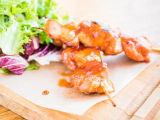 chicken with sauce on a skewer and vegetable