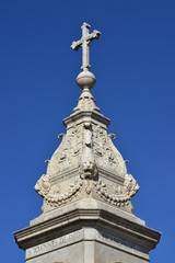 Fototapeta na wymiar Holy cross at the top of monument erected in Tiberina Island (Rome) and made by sculptor Jacometti in 1869