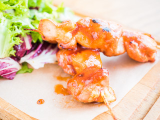 chicken with sauce on a skewer and vegetable