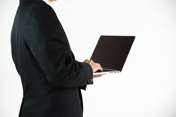 Businessman holding laptop isolated on white background.
