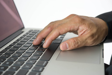 Close-up of hands typing on laptop keyboard