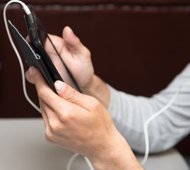 Obraz premium black tablet in man's hands